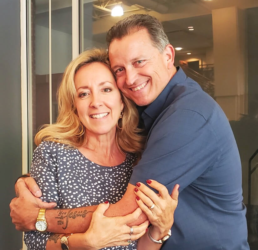 Picture of podcast co-hosts Carey Green & Mindi Green, hugging.